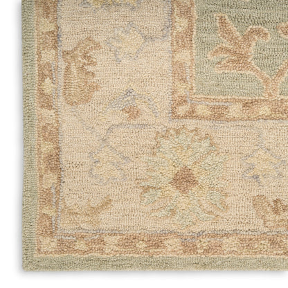 Close-up of a cream textured rug corner with pastel floral motifs, tan border and soft blue accents.