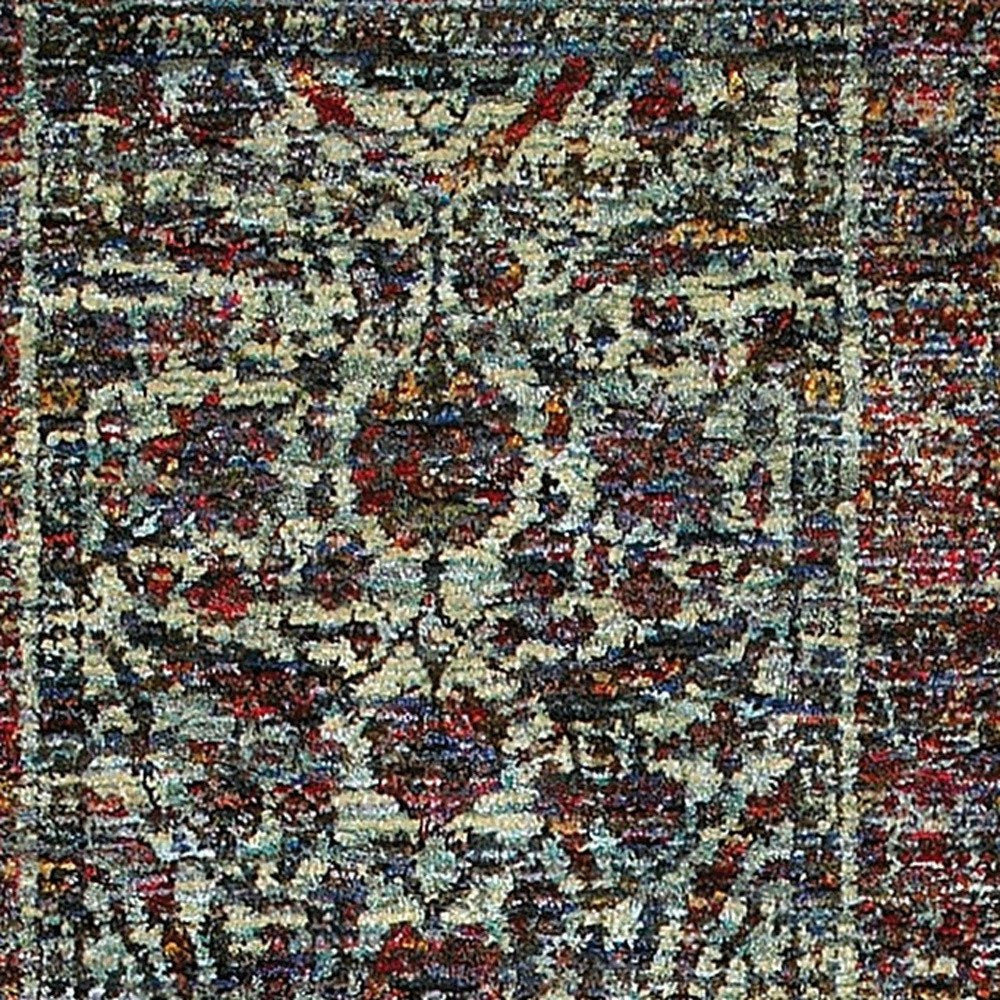 Intricate Persian-style rug with faded blue, ivory and burgundy floral motifs and a bordered design.