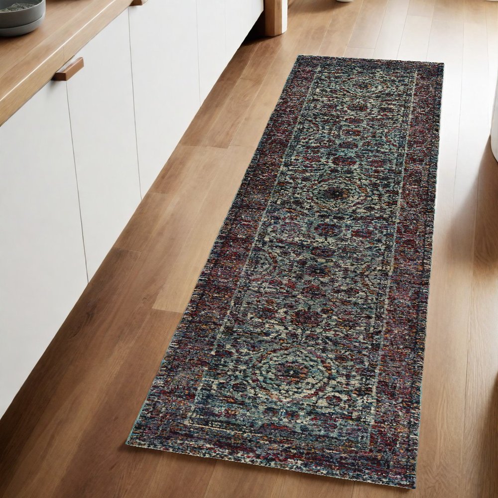 Long hallway runner rug with blue and purple Persian pattern on warm wood floor.