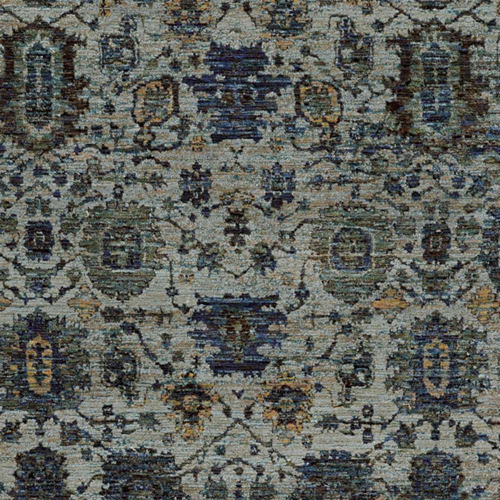 Blue-gray oriental rug with ivory & teal motifs; distressed floral lattice pattern; soft pile.