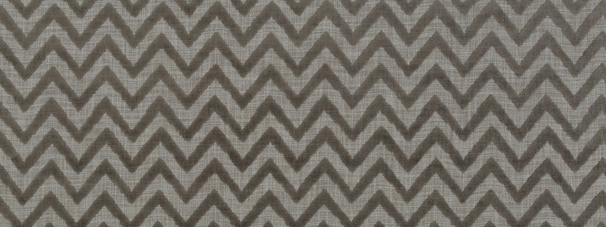 Grey chevron zigzag fabric pattern in tonal greys, geometric textile for upholstery or drapery.