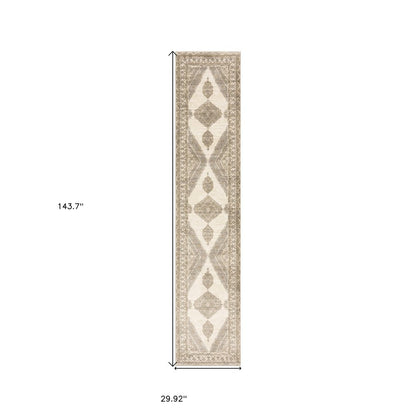 Beige & ivory runner rug with geometric diamonds & ornate border; 29.9" W x 143.7" L.