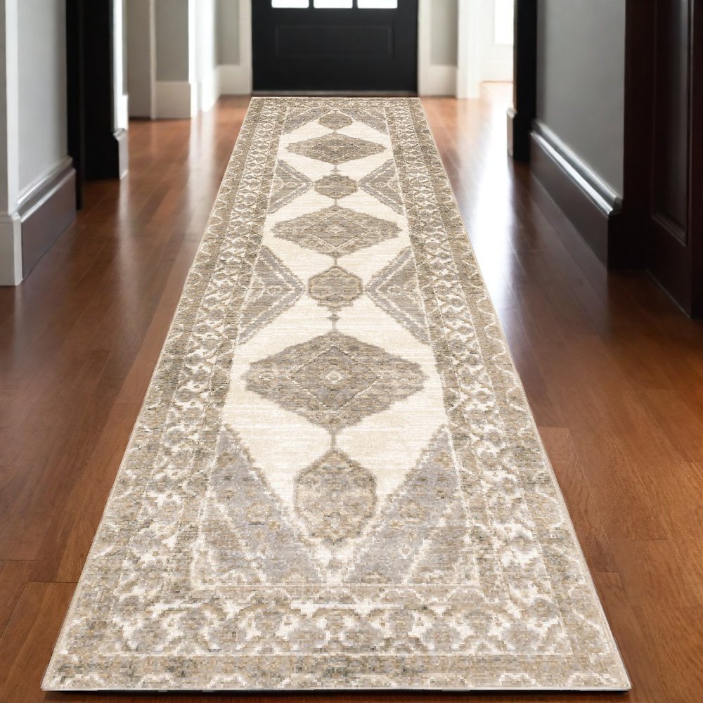 Beige oriental runner rug with geometric diamond medallions & ornate floral border on hardwood hallway