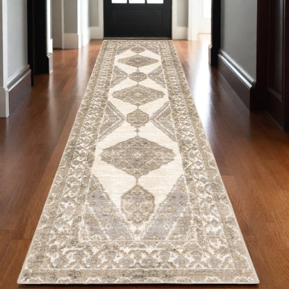 Beige oriental runner rug with geometric diamond medallions & ornate floral border on hardwood hallway
