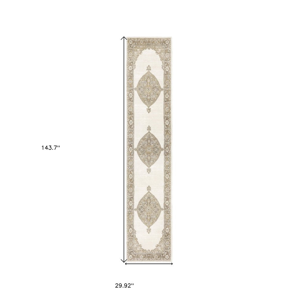 Long narrow beige and cream runner rug with taupe medallion motifs and ornate border; 143.7 x 29.92 in.