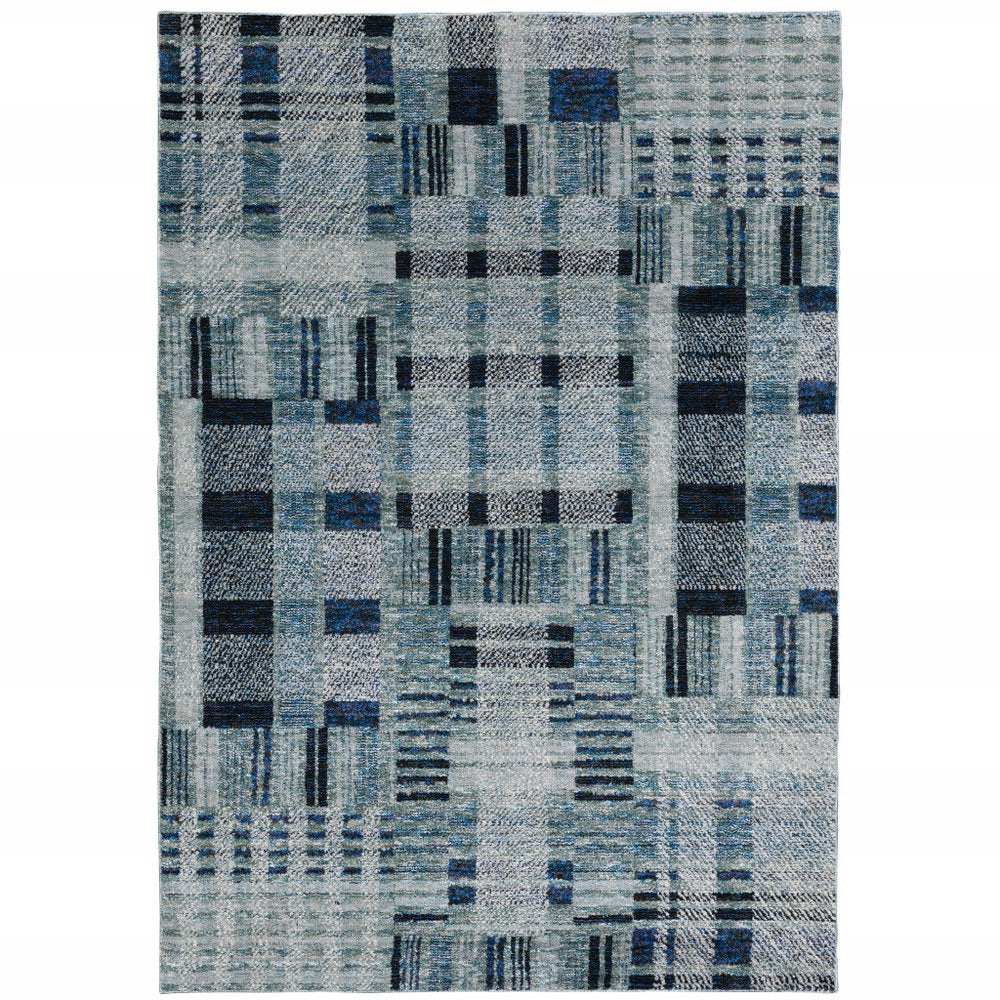 Blue-gray patchwork area rug featuring geometric rectangle blocks and lines.