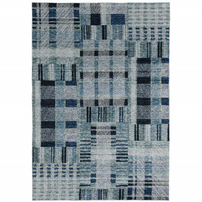 Blue-gray patchwork area rug featuring geometric rectangle blocks and lines.