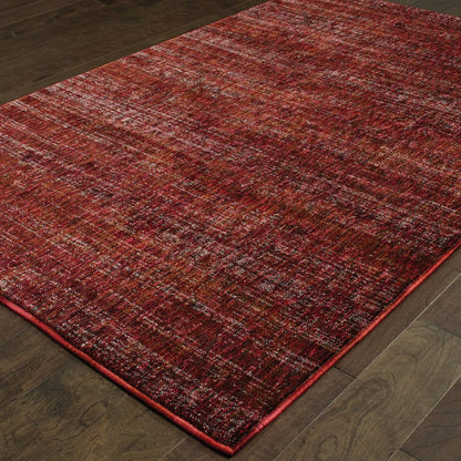 Red-toned distressed area rug with burgundy and rust hues on dark wood floor.