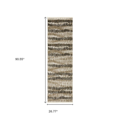 2' x 8' abstract power-loom runner rug in beige, ivory, charcoal, brown, tan and grey with fringe and stain resistant.