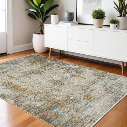 4' x 6' abstract area rug in beige, grey, brown, gold, red and blue with fringe; power-loomed, stain-resistant.