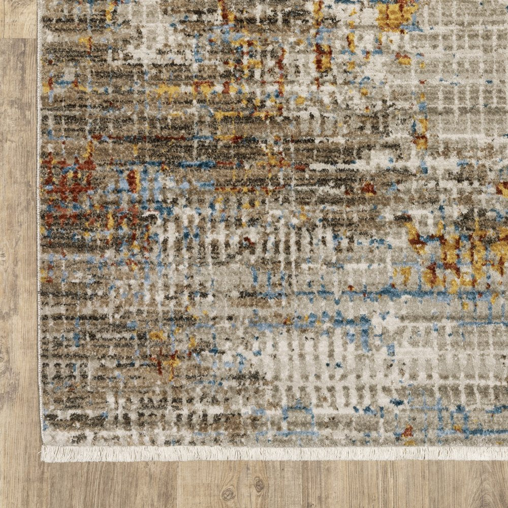 4' x 6' abstract area rug in beige, grey, brown, gold, red and blue with fringe; stain resistant; power loom construction