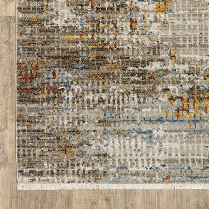 4' x 6' abstract area rug in beige, grey, brown, gold, red and blue with fringe; stain resistant; power loom construction