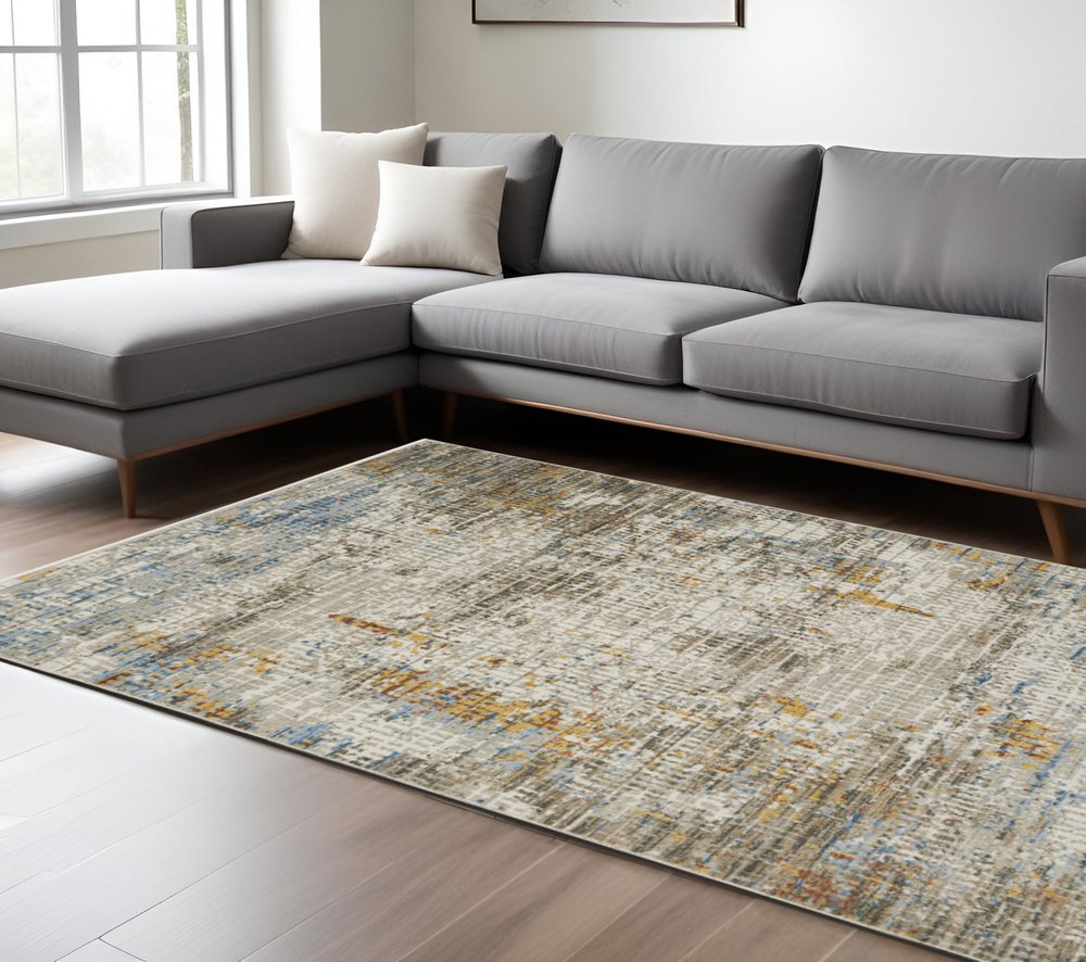 6' x 9' beige grey brown gold red and blue abstract power loom area rug with fringe, stain resistant