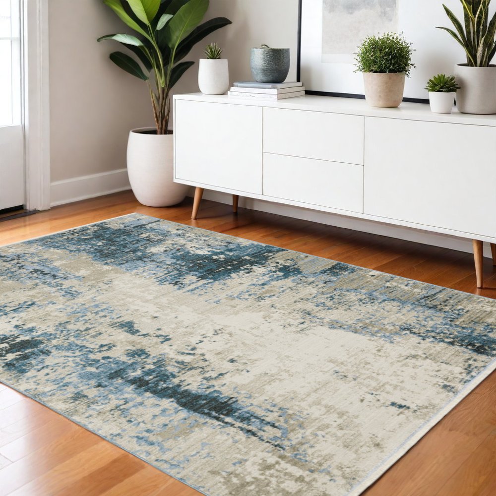 4' X 6' Blue Grey Ivory Light Blue And Dark Blue Abstract Power Loom Stain Resistant Area Rug With Fringe