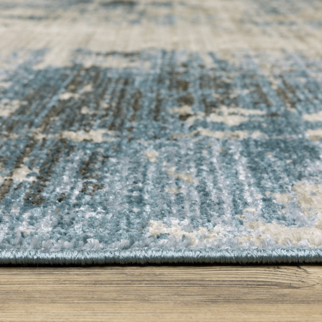 4' X 6' Blue Grey Ivory Light Blue And Dark Blue Abstract Power Loom Stain Resistant Area Rug With Fringe