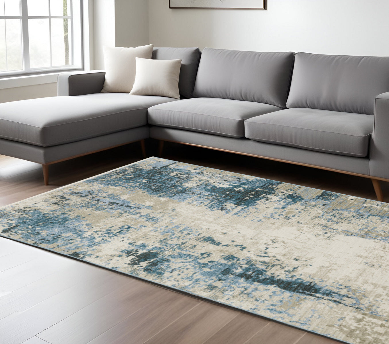 6' X 9' Blue Grey Ivory Light Blue And Dark Blue Abstract Power Loom Stain Resistant Area Rug With Fringe