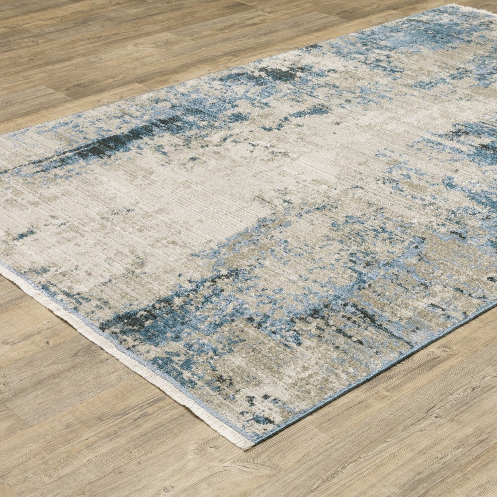 6' x 9' blue grey ivory light blue and dark blue abstract power loom stain resistant area rug with fringe