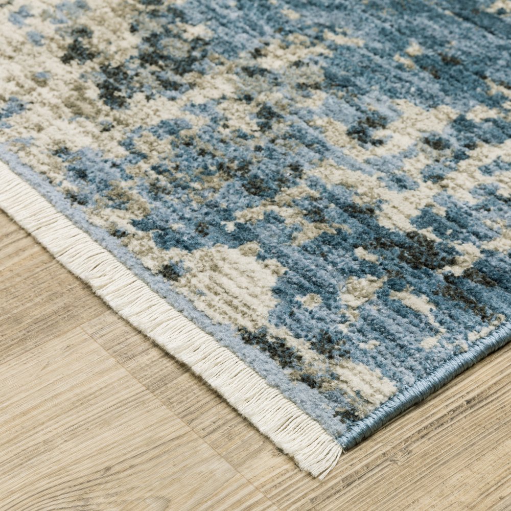 8' X 11' Blue Grey Ivory Light Blue And Dark Blue Abstract Power Loom Stain Resistant Area Rug With Fringe