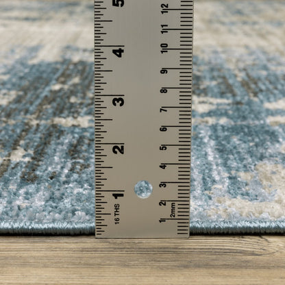 8' X 11' Blue Grey Ivory Light Blue And Dark Blue Abstract Power Loom Stain Resistant Area Rug With Fringe