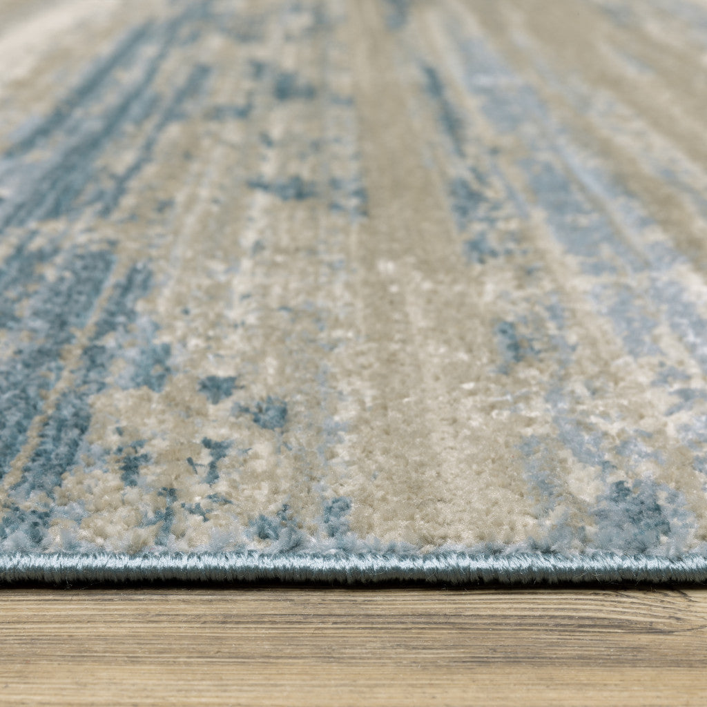 4' X 6' Ivory Beige Grey Blue And Tan Abstract Power Loom Stain Resistant Area Rug With Fringe