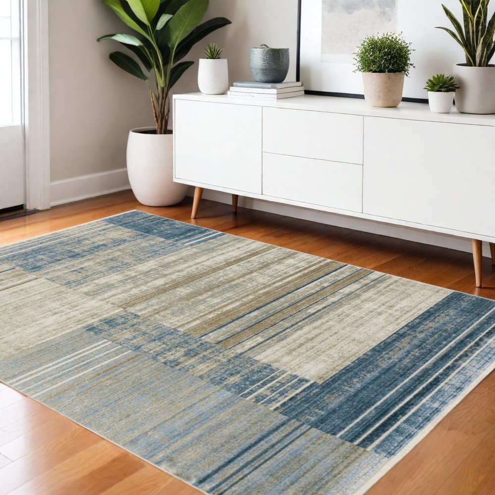 4' x 6' blue, dark blue, teal, grey, ivory, beige and tan geometric power loom stain-resistant area rug with fringe