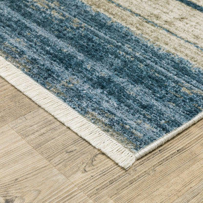 4' X 6' Blue Dark Blue Teal Grey Ivory Beige And Tan geometric power loom stain resistant area rug with fringe