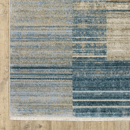 4' x 6' blue, dark blue, teal, grey, ivory, beige and tan geometric Power Loom stain-resistant area rug with fringe.