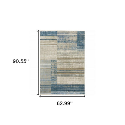 5' x 8' area rug in blue, dark blue, teal, grey, ivory, beige and tan with a geometric pattern; power-loomed, stain resistant, with fringe.
