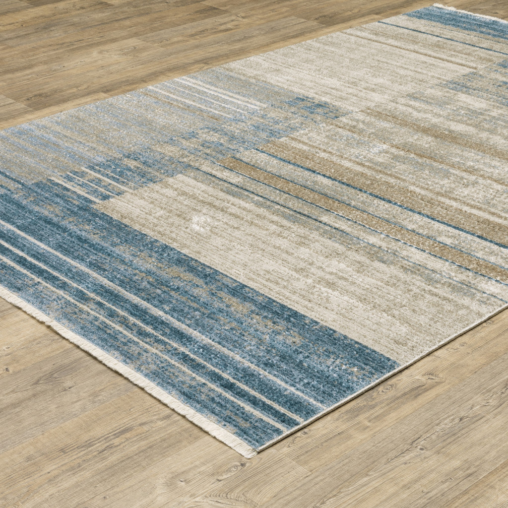 5' X 8' Blue Dark Blue Teal Grey Ivory Beige And Tan Geometric Power Loom Stain Resistant Area Rug With Fringe