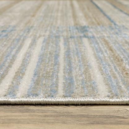 5' X 8' blue, dark blue, teal, grey, ivory, beige and tan geometric power loom stain resistant area rug with fringe