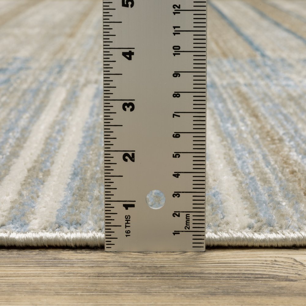 8' X 11' Blue Dark Blue Teal Grey Ivory Beige And Tan Geometric Power Loom Stain Resistant Area Rug With Fringe