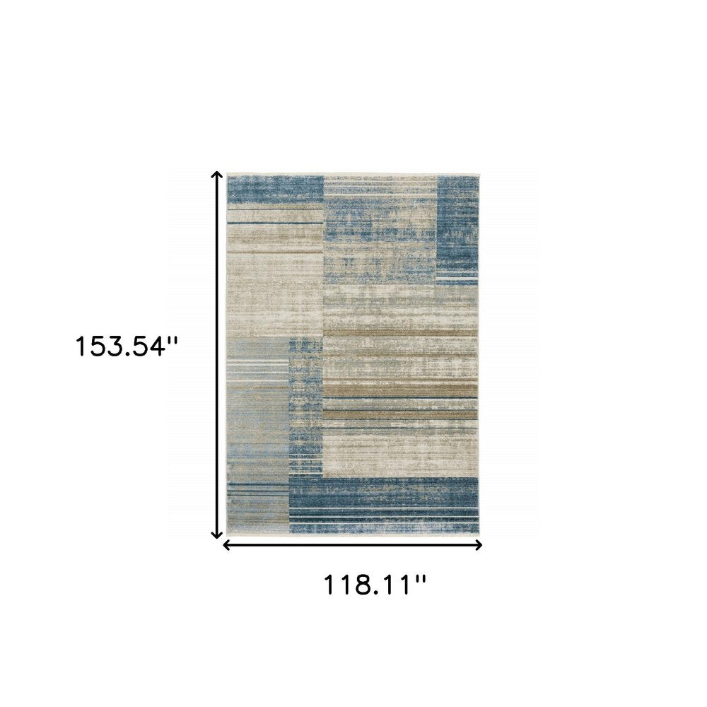 10' X 13' Blue, Dark Blue, Teal, Grey, Ivory, Beige and Tan Geometric Power Loom Stain Resistant Area Rug With Fringe