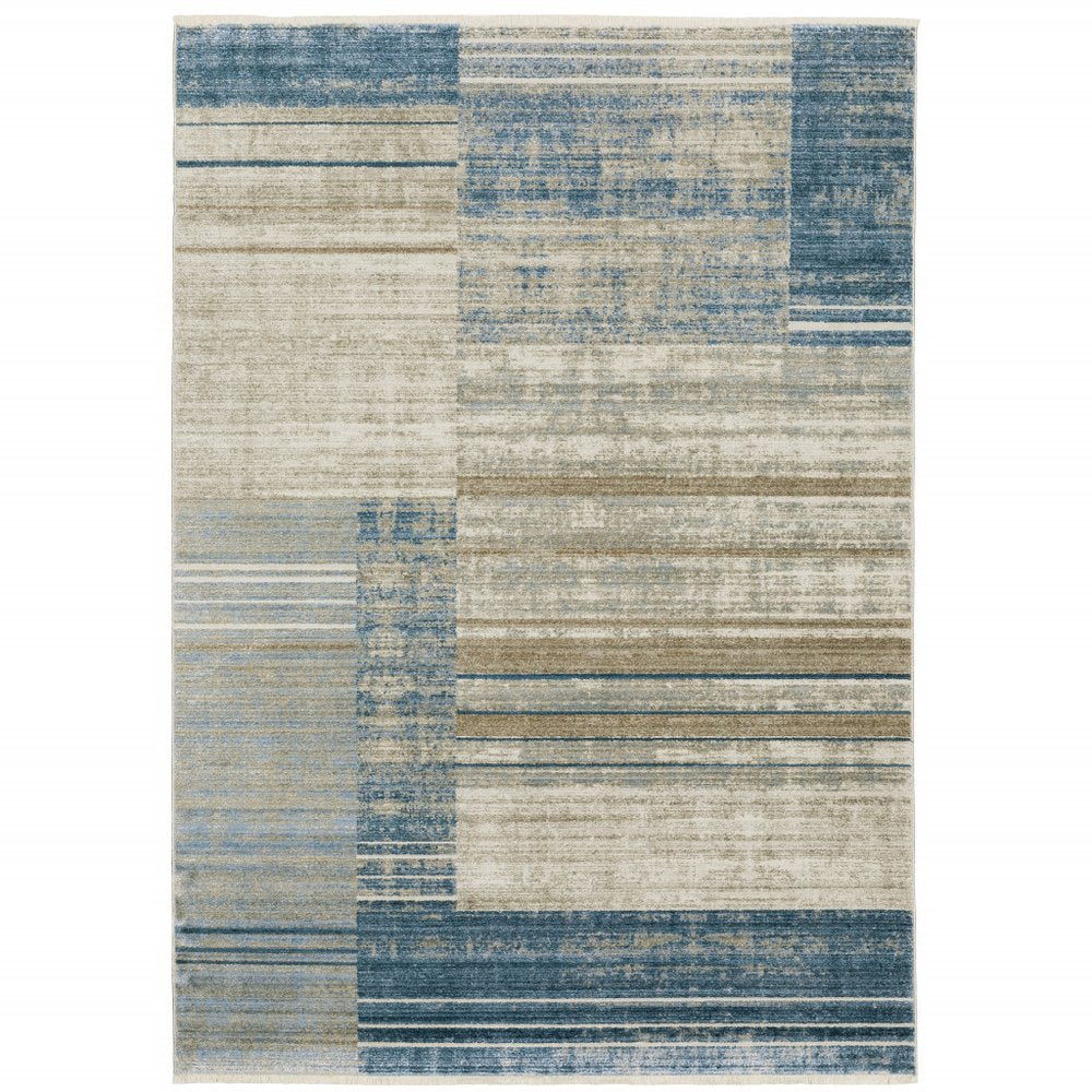 10' X 13' geometric area rug in blue, dark blue, teal, grey, ivory, beige and tan with fringe; power loom; stain resistant.