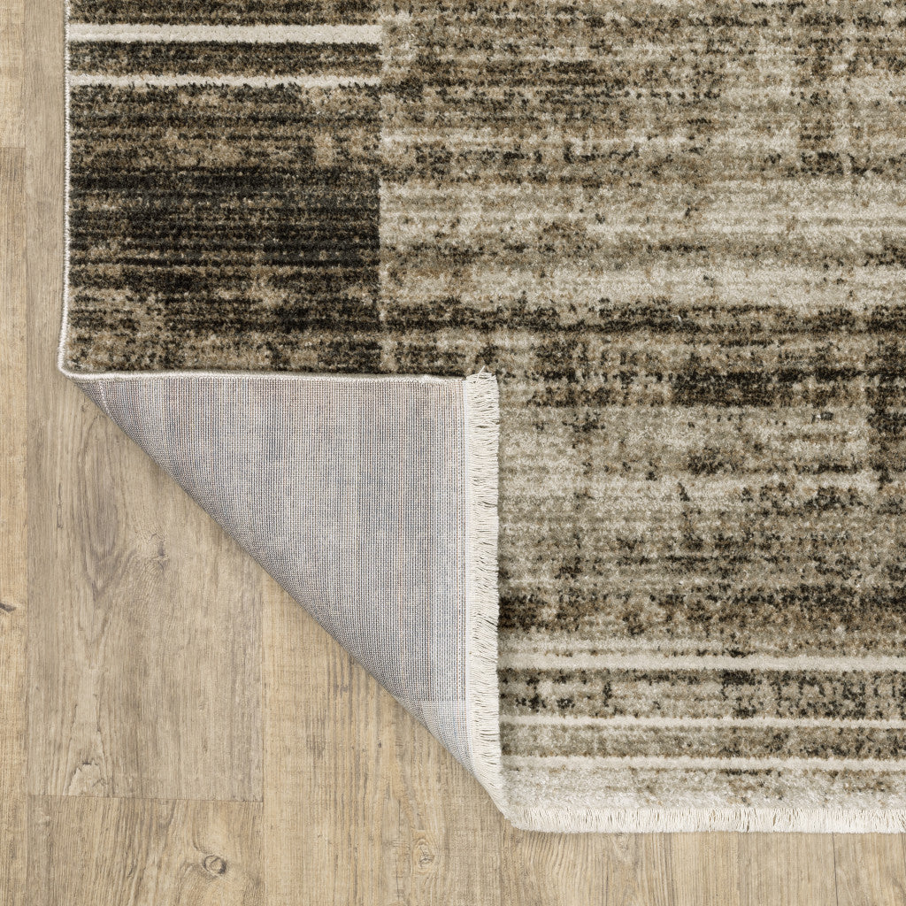 5' X 8' Beige Charcoal Brown Grey Tan Gold And Blue Geometric Power Loom Stain Resistant Area Rug With Fringe