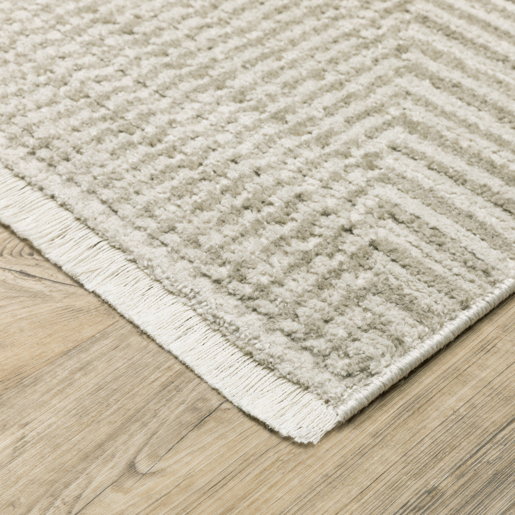 5' X 8' Ivory Beige Taupe And Tan Geometric Power Loom Stain Resistant Area Rug With Fringe
