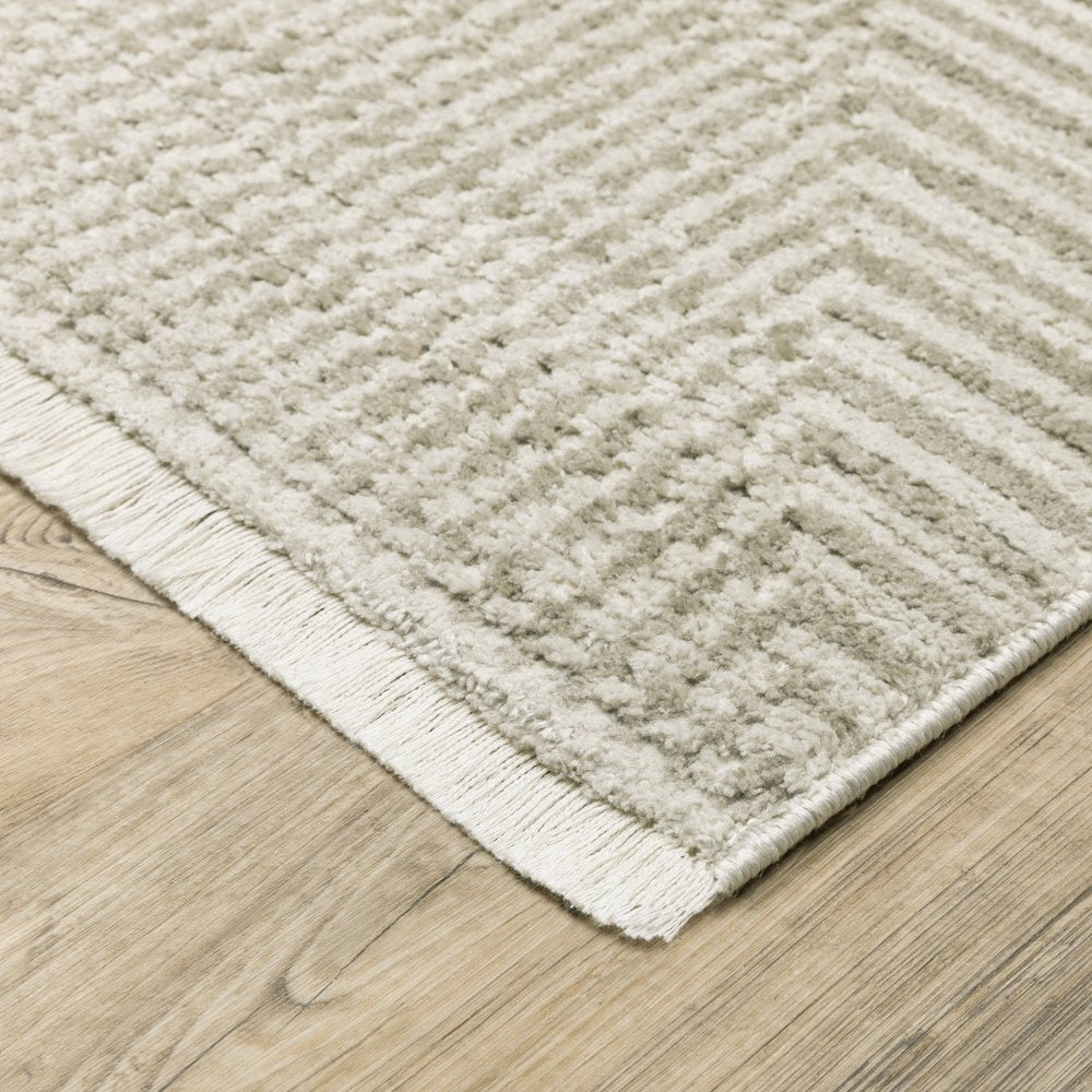 5' x 8' ivory, beige, taupe and tan geometric area rug, power loom, stain resistant, with fringe