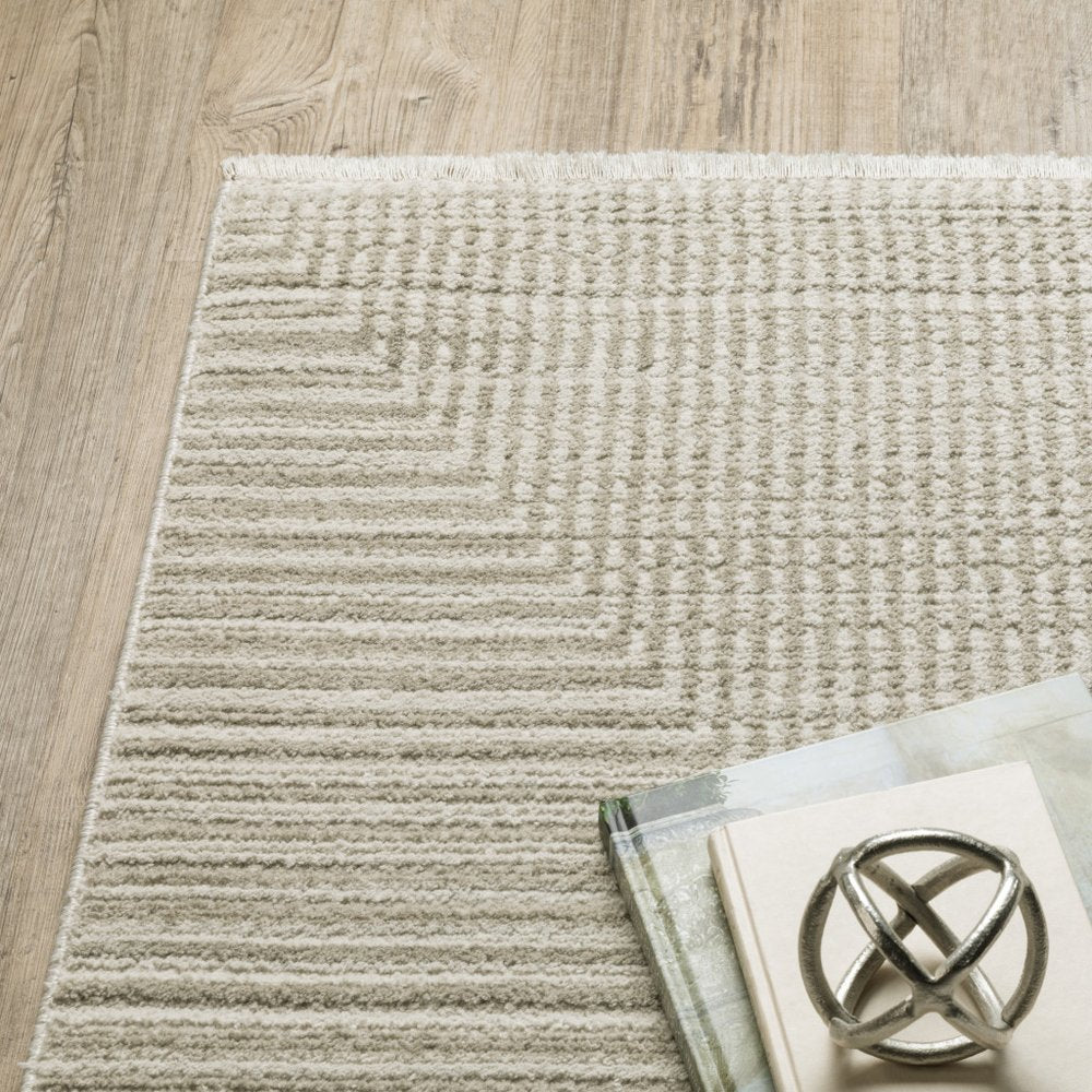 5' x 8' ivory beige taupe and tan geometric power loom stain-resistant area rug with fringe