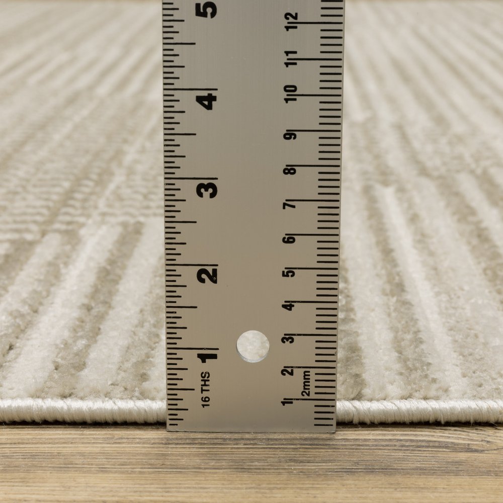 5' x 8' ivory, beige, taupe and tan geometric power-loom area rug with fringe; stain-resistant