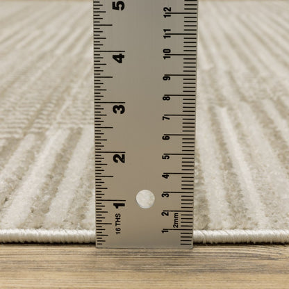 5' x 8' ivory, beige, taupe and tan geometric power-loom area rug with fringe; stain-resistant