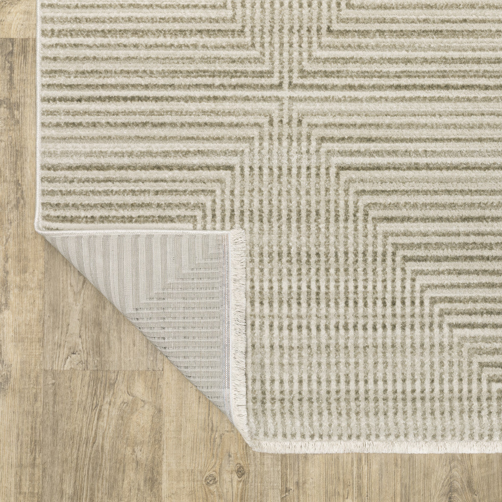 10' X 13' Ivory Beige Taupe And Tan Geometric Power Loom Stain Resistant Area Rug With Fringe