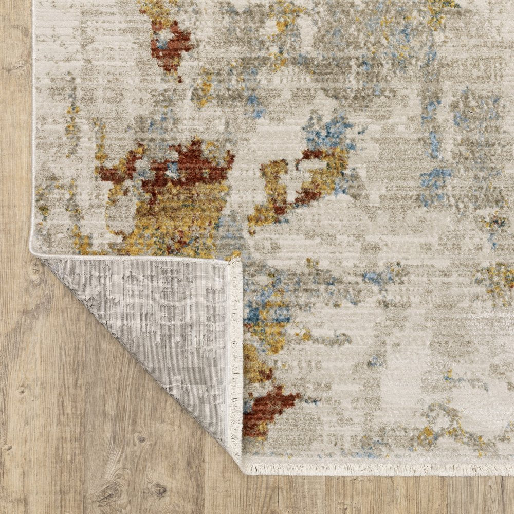 4' X 6' Beige Grey Gold Blue Rust And Teal Abstract Power Loom Stain Resistant Area Rug With Fringe