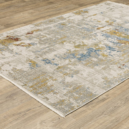 6' x 9' abstract power loom stain-resistant area rug in beige, grey, gold, blue, rust and teal with fringe