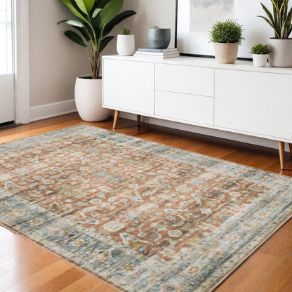 5' X 7' Rust Blue Ivory And Gold Oriental Printed Stain Resistant Non Skid Area Rug