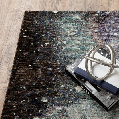 Multicolor abstract runner rug in brown to teal tones on wood floor, stacked books topped by a silver geometric sculpture.