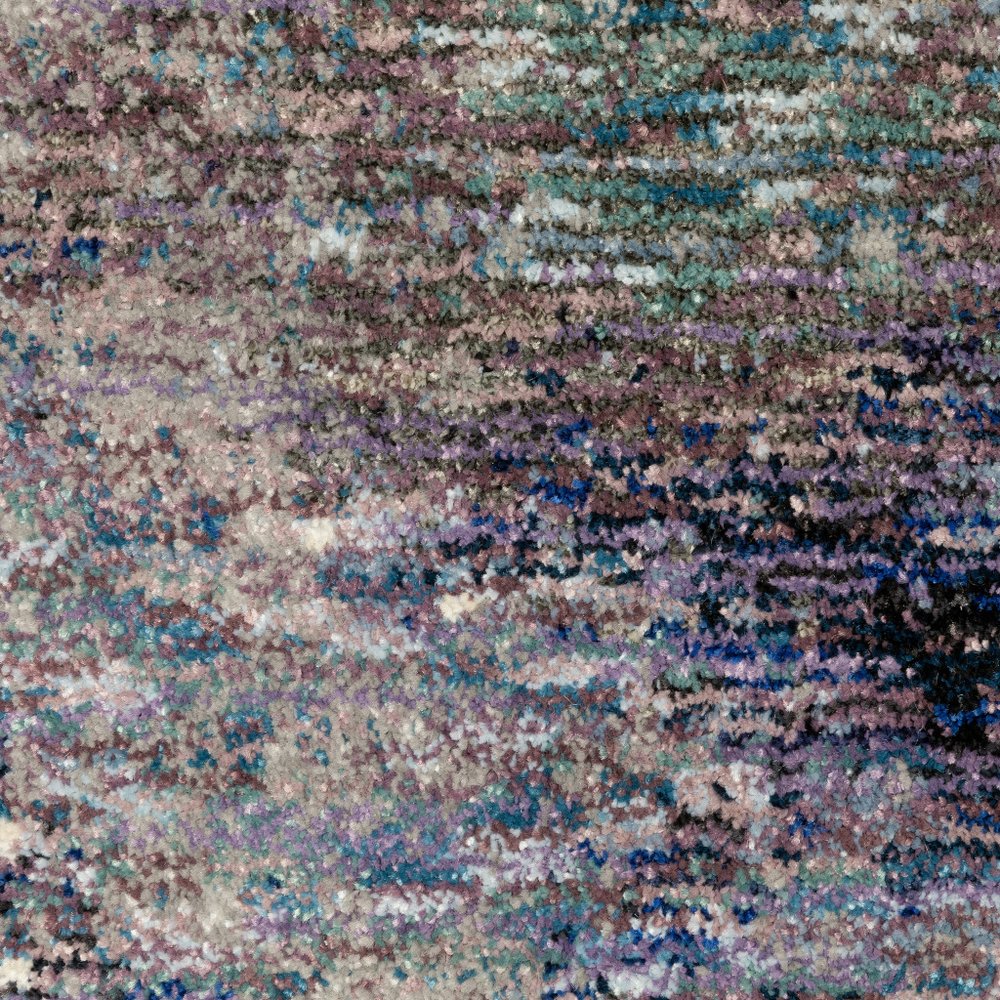 12' long soft, multicolor abstract runner rug with purple, teal and brown tones and an irregular pattern.