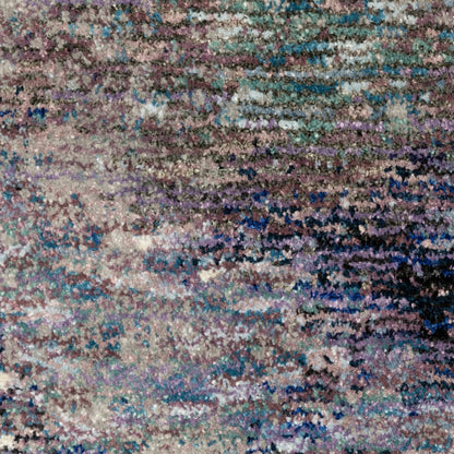 12' long soft, multicolor abstract runner rug with purple, teal and brown tones and an irregular pattern.