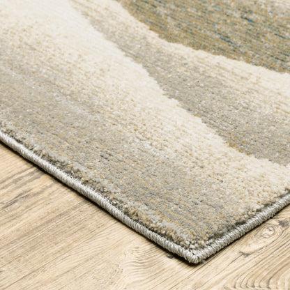 Soft striped area rug in cream, beige and gray tones with plush pile and bound edge on a wooden floor.