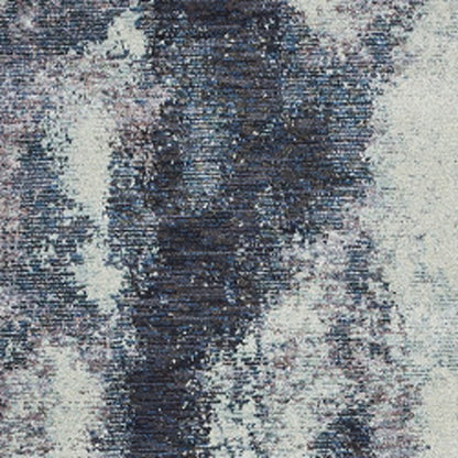 Close-up of an ivory abstract runner rug; woven textile with a modern abstract design.
