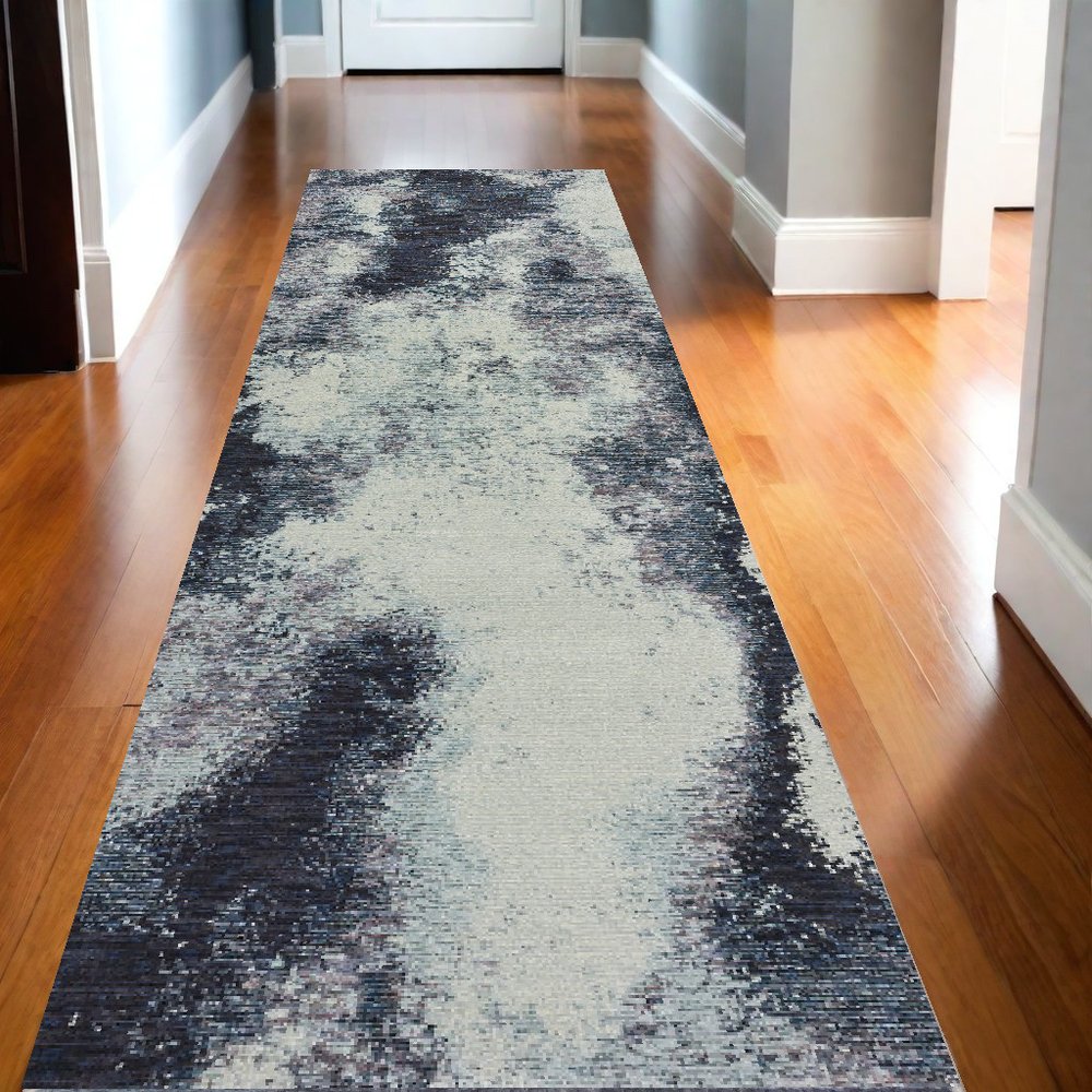 Ivory abstract hallway runner rug on warm wood floors.