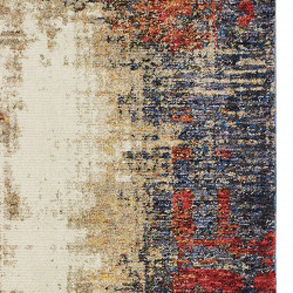Abstract distressed area rug with cream left side and navy blue, red, and gold pattern.
